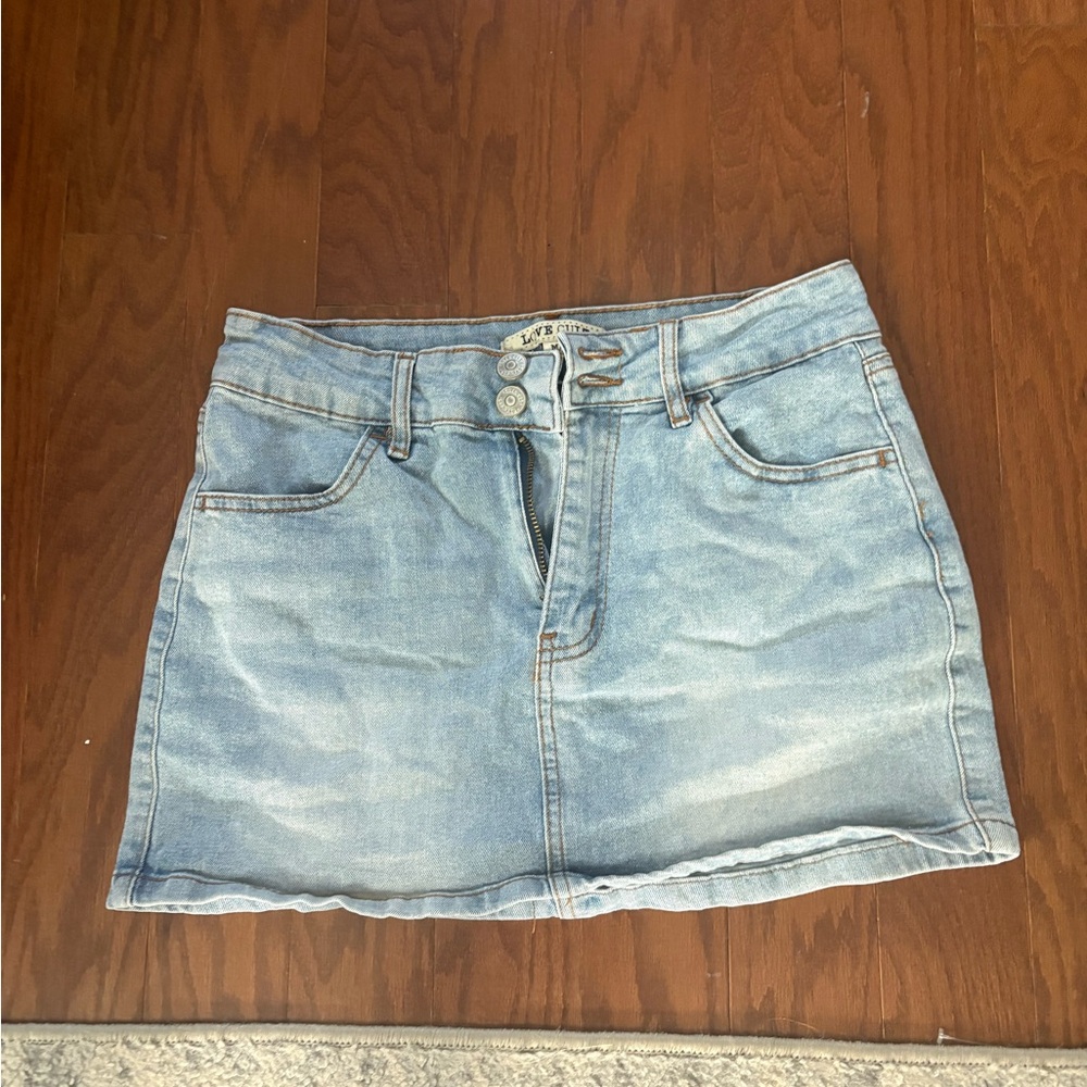 Light wash denim mini skirt with button